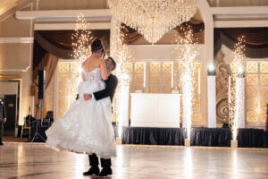 Bride and groom dancing with four cold spark fountains and a white DJ booth at The Venetian wedding venue in New Jersey