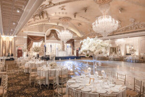Elegant wedding uplighting by DJ Taso illuminating the ballroom at The Venetian in Garfield, NJ